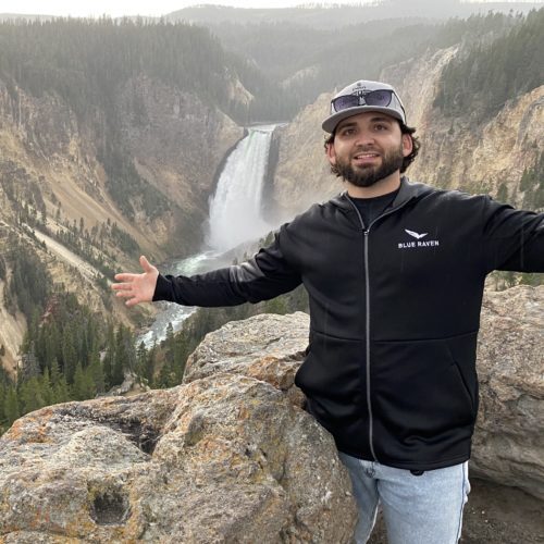 Man in front of waterfall