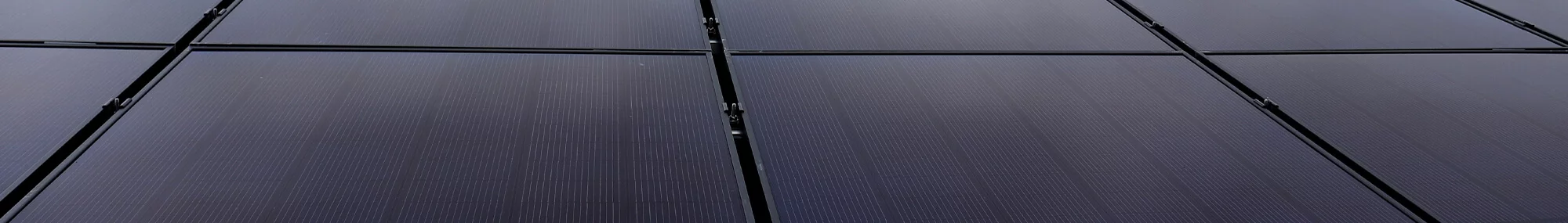 Solar panels installed close together in a grid pattern