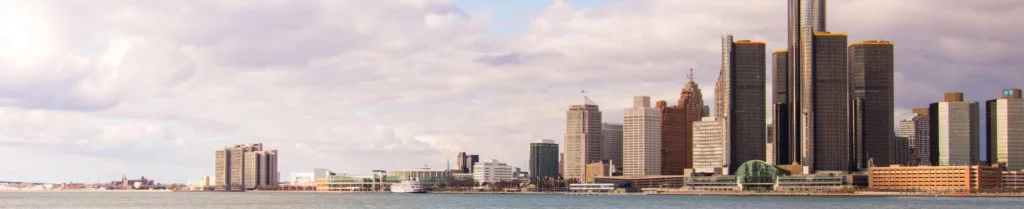 Downtown preview of Michigan, surrounded by water and large skyscraper buildings and low clouds