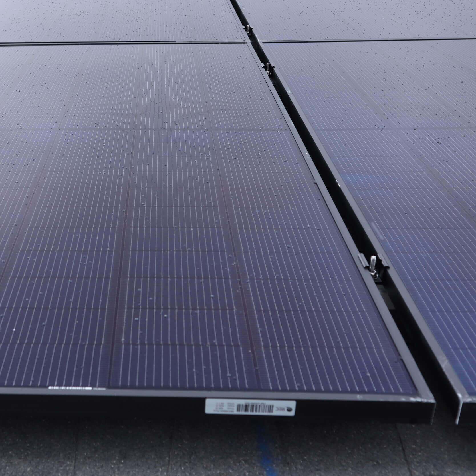 Up close view of solar panels installed on roof, in a grid