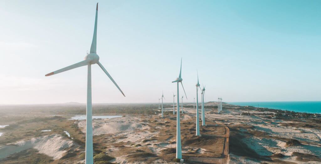 Wind turbine along the beach, representing a form of clean energy