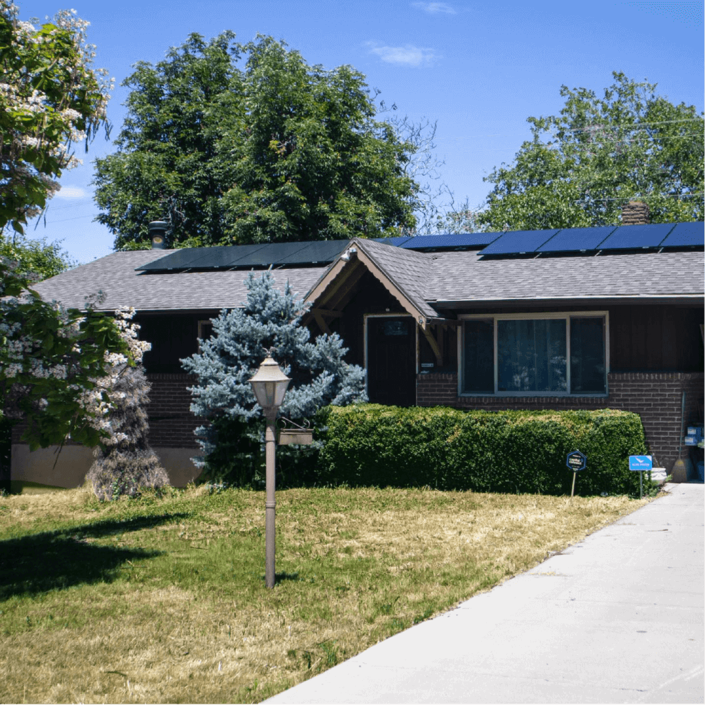 Single level house with neutral tones and custom solar panel system installed on front of house