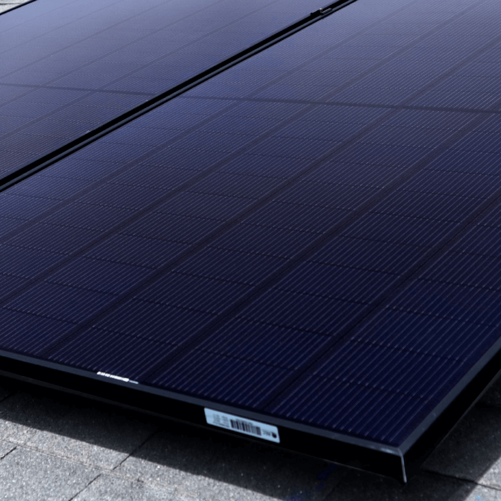 Up close view of solar panel array, shot from the corner and deep blue tones