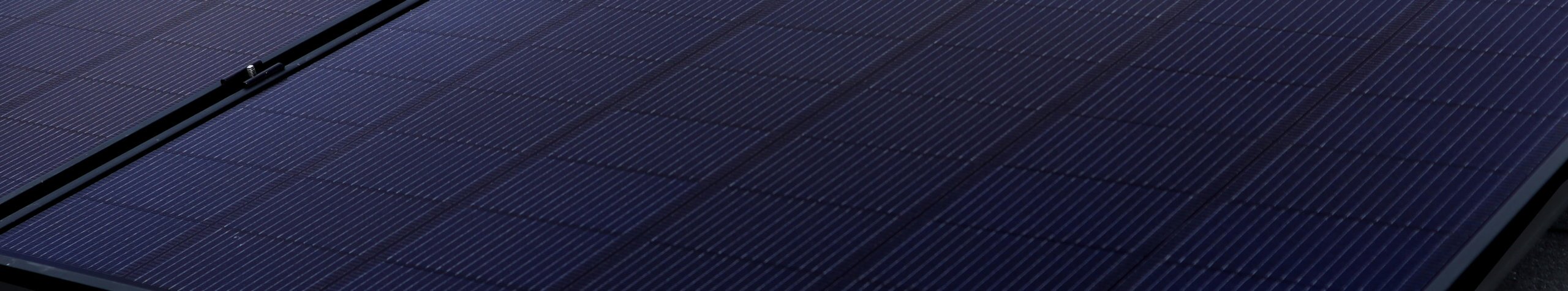 Zoomed in view of solar panel installed on roof, focusing on individual solar cells