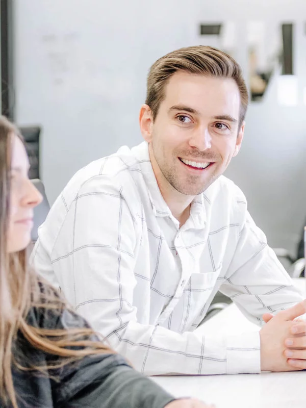 Two Blue Raven Solar employees, a female and male, in a large conference room