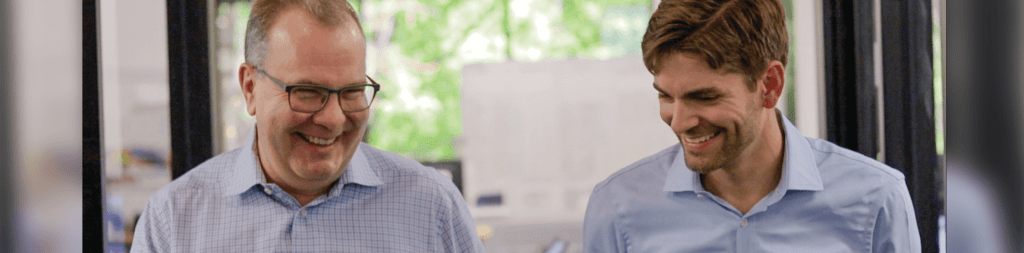 Two males in button-up shirts, Peter Faricy, CEO of SunPower and Ben Peterson, CEO of Blue Raven Solar