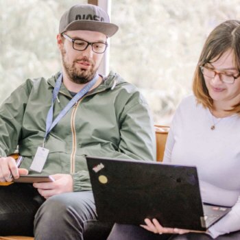 Blue Raven Solar employees, working together on a laptop