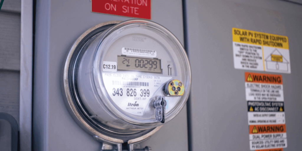 Up close view of a utility meter, attached to a house