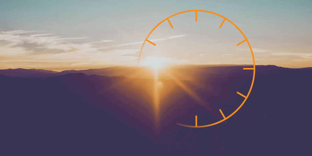 Sunset with large sun flare and an incomplete thin-line, orange icon similar to a clock
