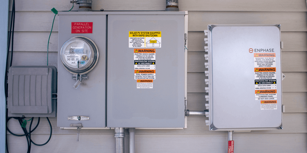 Utility including electrical panels and meters, attached to a house