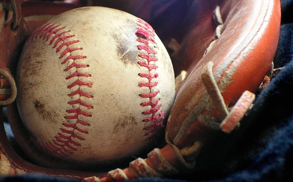 Baseball-in-Baseball Glove Used baseball in a baseball mit, up close