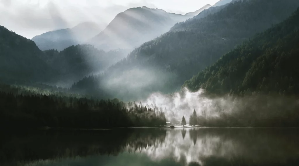 Are Solar Panels Worth It-03 Lake with mountains in the background with the sun peaking through and low clouds