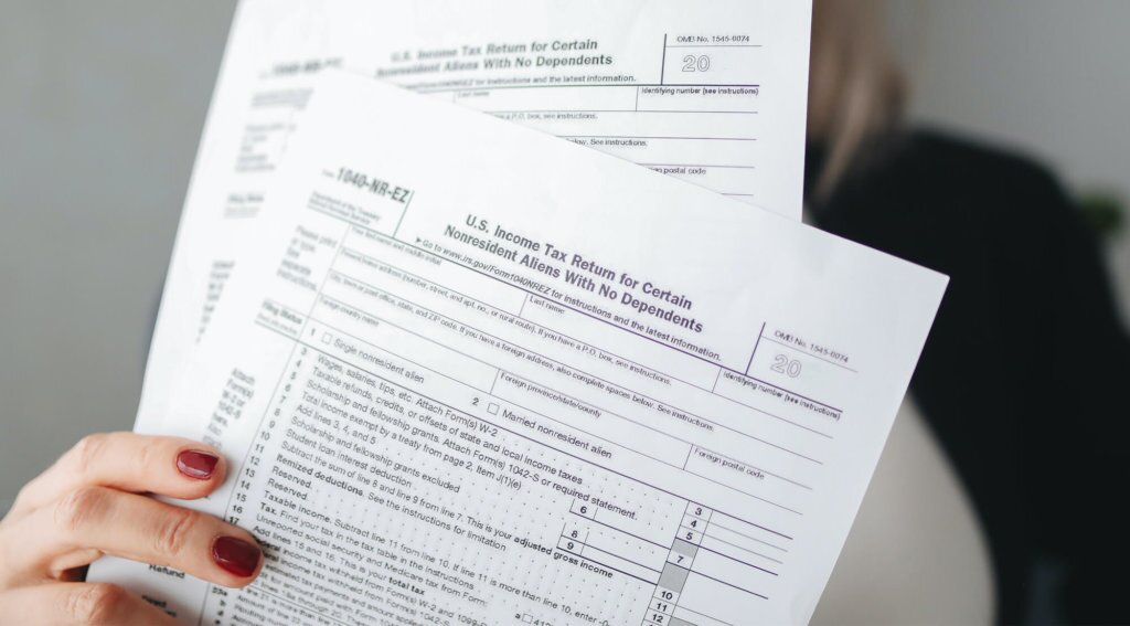 female holding solar tax credit documents