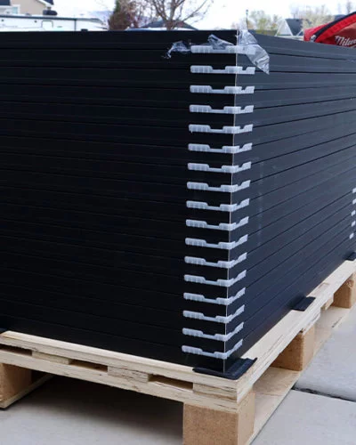 Series of solar panels stacked on wood pallet