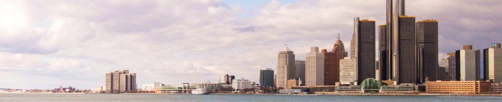 Downtown preview of Michigan, surrounded by water and large skyscraper buildings and low clouds