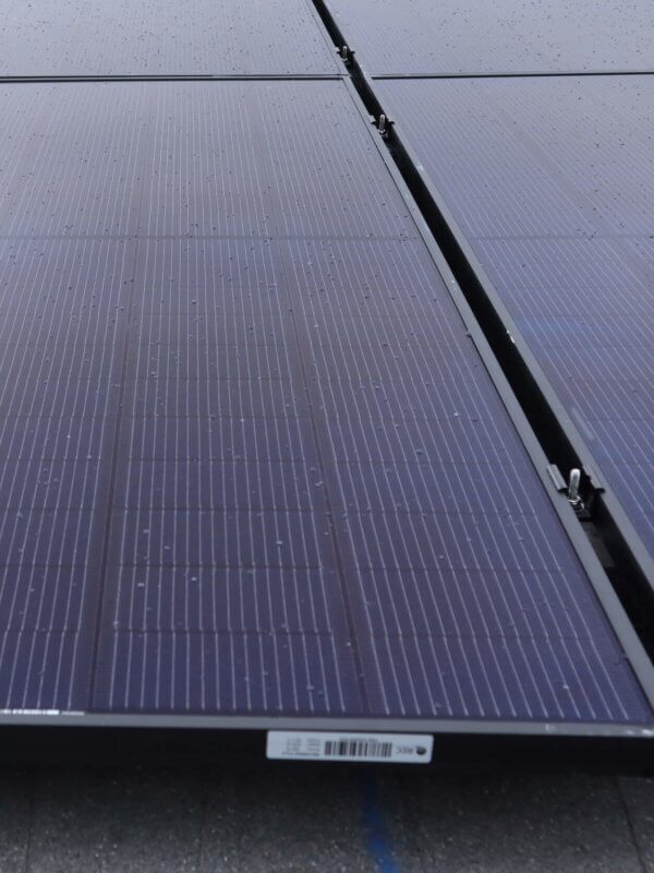 Up close view of solar panels installed on roof, in a grid