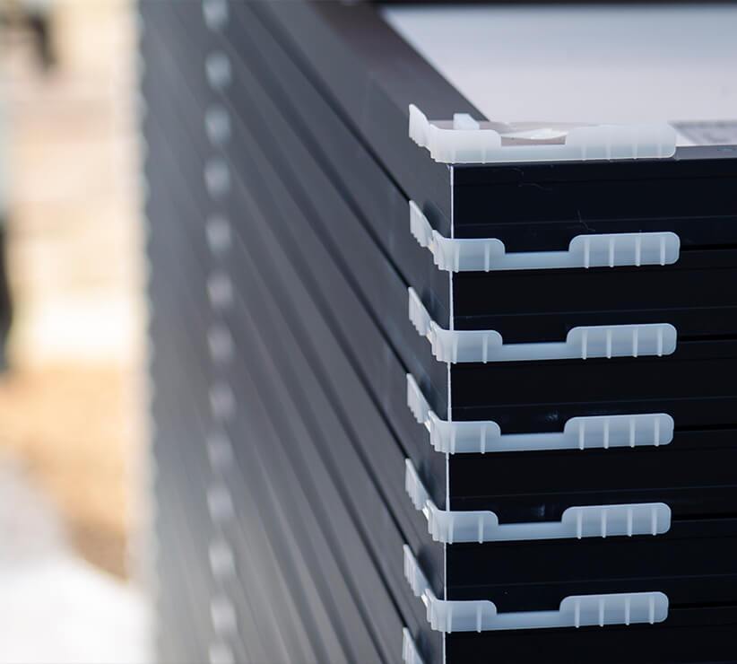 Solar panels stacked on top of each other with plastic separators between each