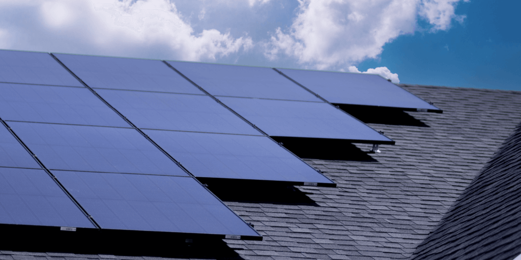 Best Residential Solar Panels-06 Multiple monocrystalline solar panels installed on a roof with bright clouds in the background