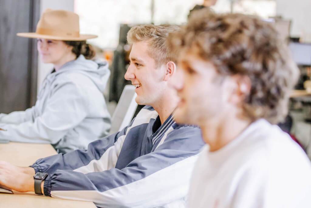 Three Blue Raven Solar employees sitting at their desks, working