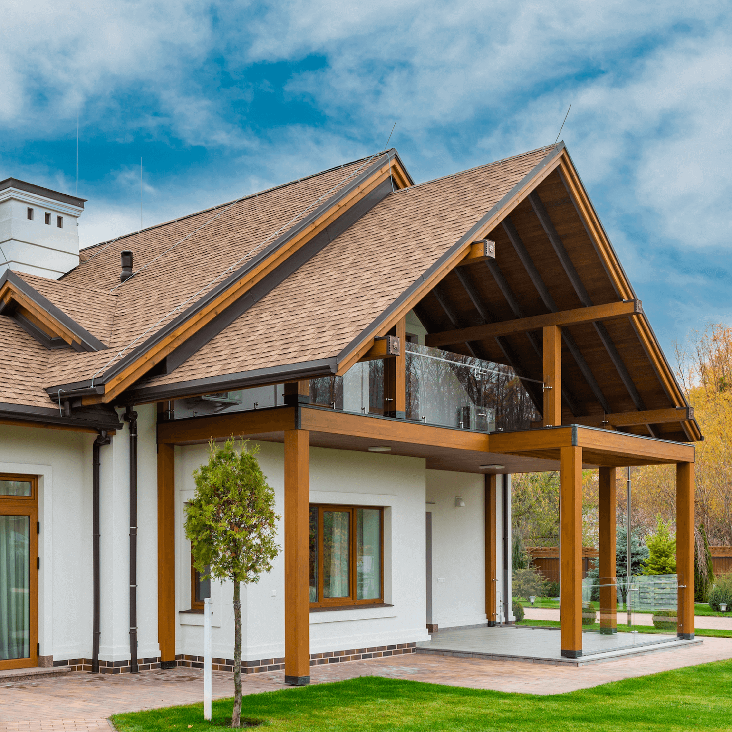 White, single-level house with exposed beams and high pitched roof line
