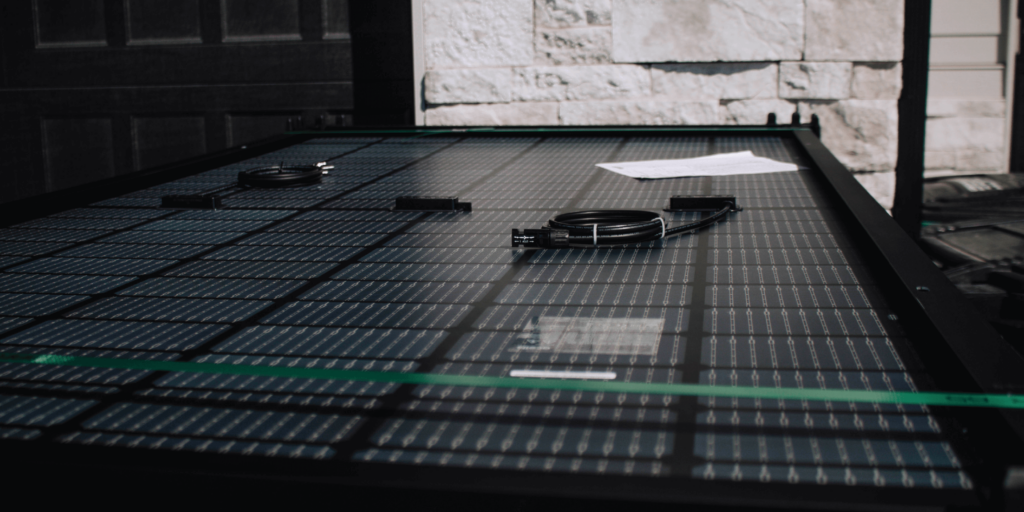 Solar panel with cords and electrical cables on top, in preparation for an installation