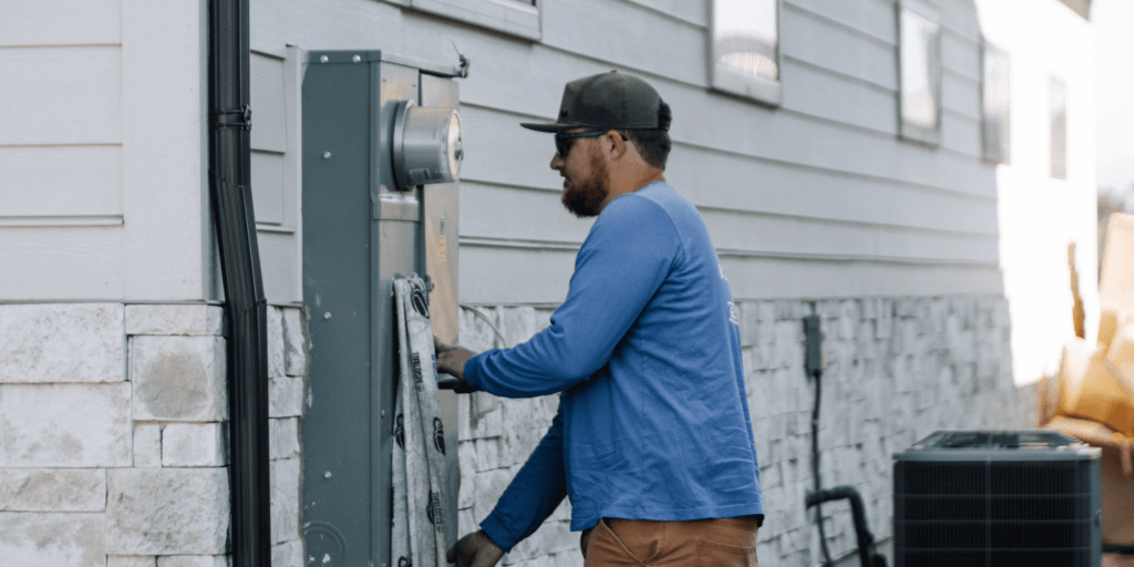 A Guide to Solar Panel Efficiency and Performance-05 Blue Raven Solar electrician upgrading the meter in preparation for solar panel installation