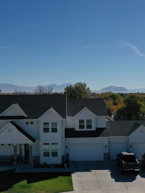 Exterior, front view of a white multi-level house