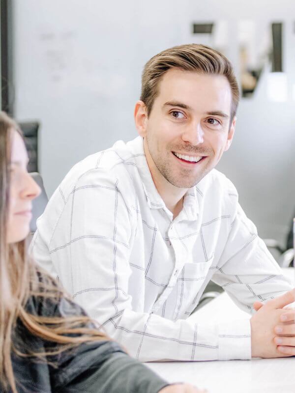 Two Blue Raven Solar employees, a female and male, in a large conference room