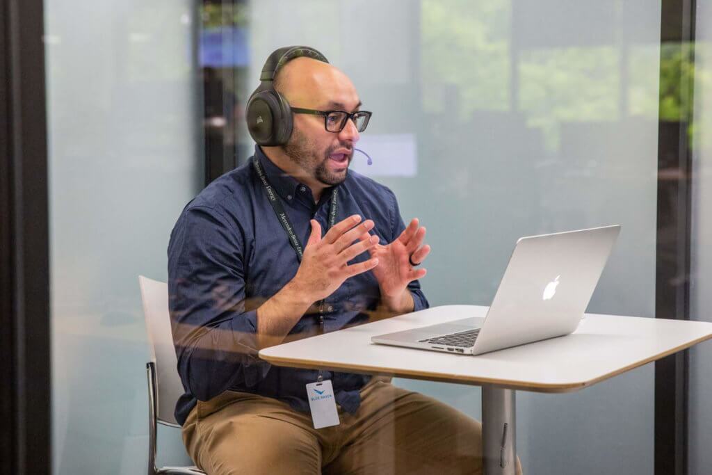 Blue-Raven-Solar-Employee-on-a-Call-in-a-Conference-Room Blue Raven Solar representative on a video call in a conference room