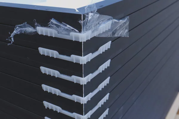 Close-Up-of-Stacked-Panels Up close view of solar panels stacked on top of each other on a wood pallet