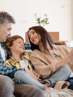 Family-on-Couch Family of three, sitting on the couch smiling and taking a polaroid picture together