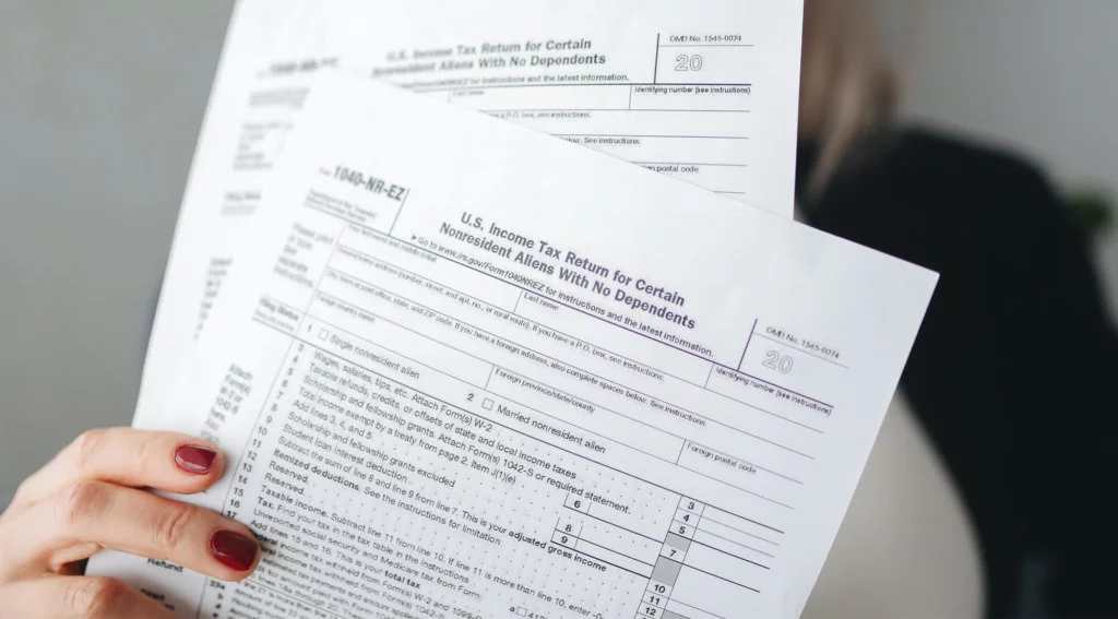 female holding solar tax credit documents