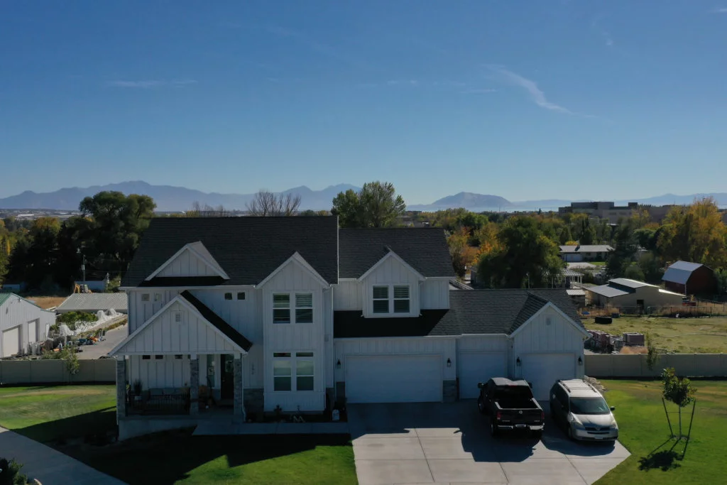 Exterior, front view of a white multi-level house