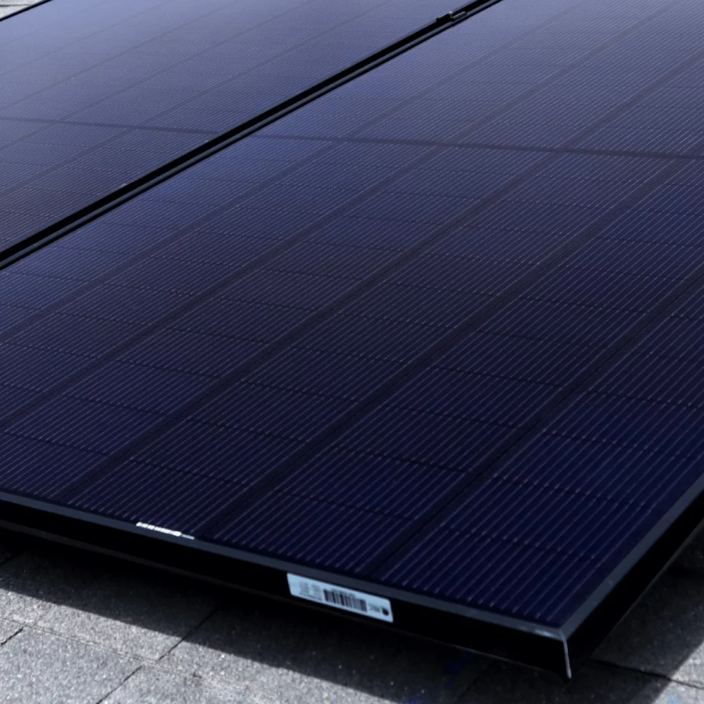 Up close view of solar panel array, shot from the corner and deep blue tones