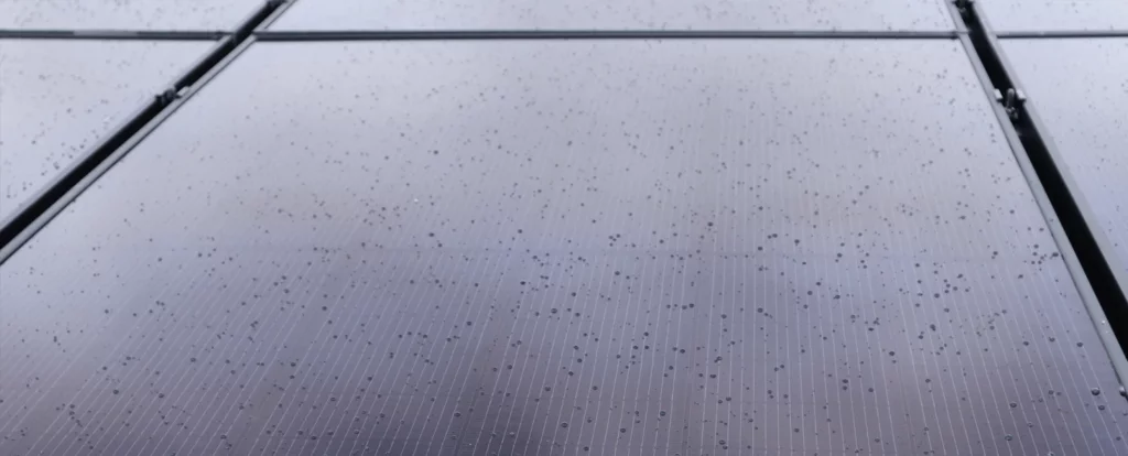 Cleaning Panels Up close view of six solar panel system with rain drops on the surface