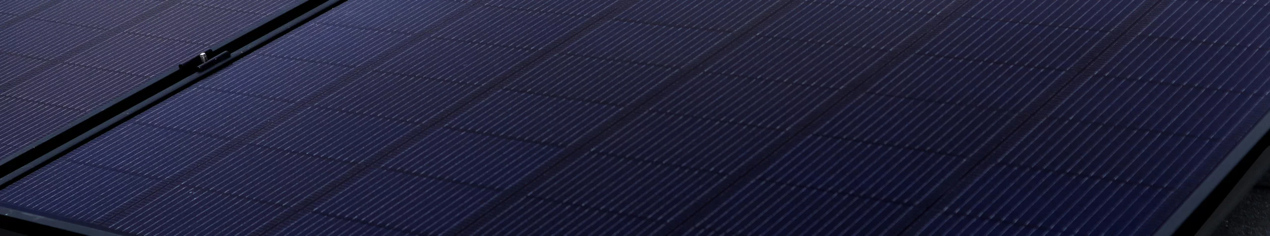 Zoomed in view of solar panel installed on roof, focusing on individual solar cells