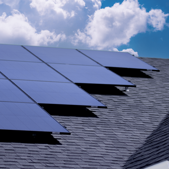 Multiple monocrystalline solar panels installed on a roof with bright clouds in the background. Best Residential Solar Panels.