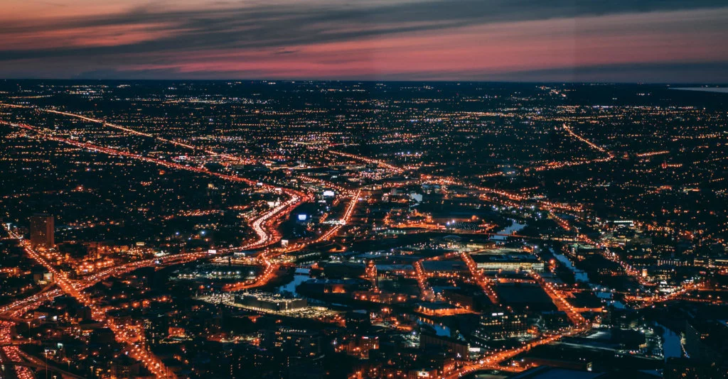 City-at-Night-with-Lights Heavily populated city at night with bright lights appearing as electricity running through the city
