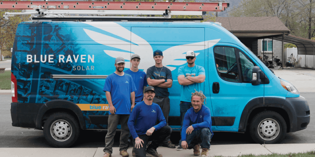 Six Blue Raven Solar installers standing in front of a branded van in preparation for system install