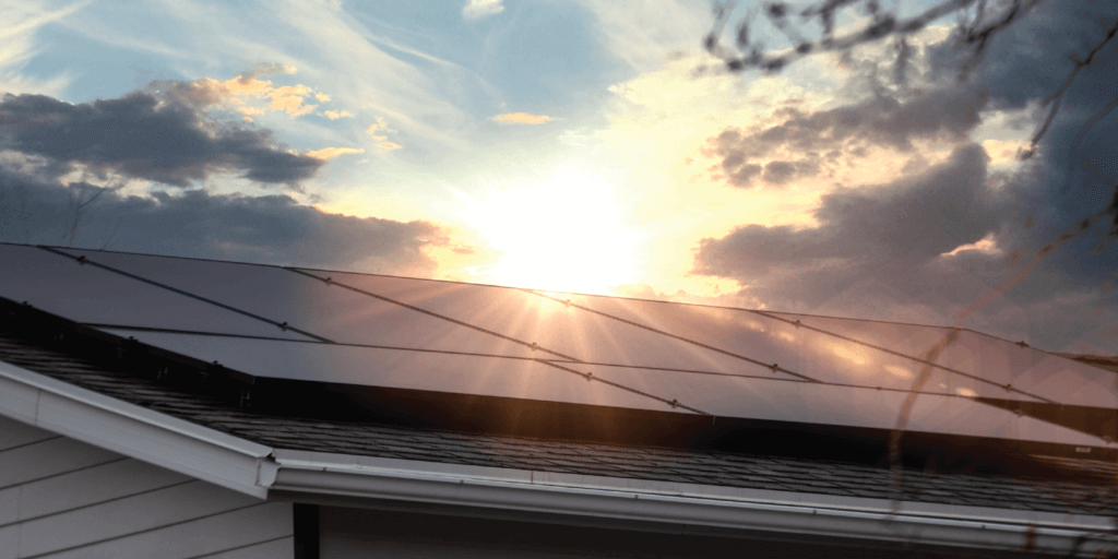 Are Solar Panels Waterproof-03 Custom solar panel system installed on roof with sun gleaming behind