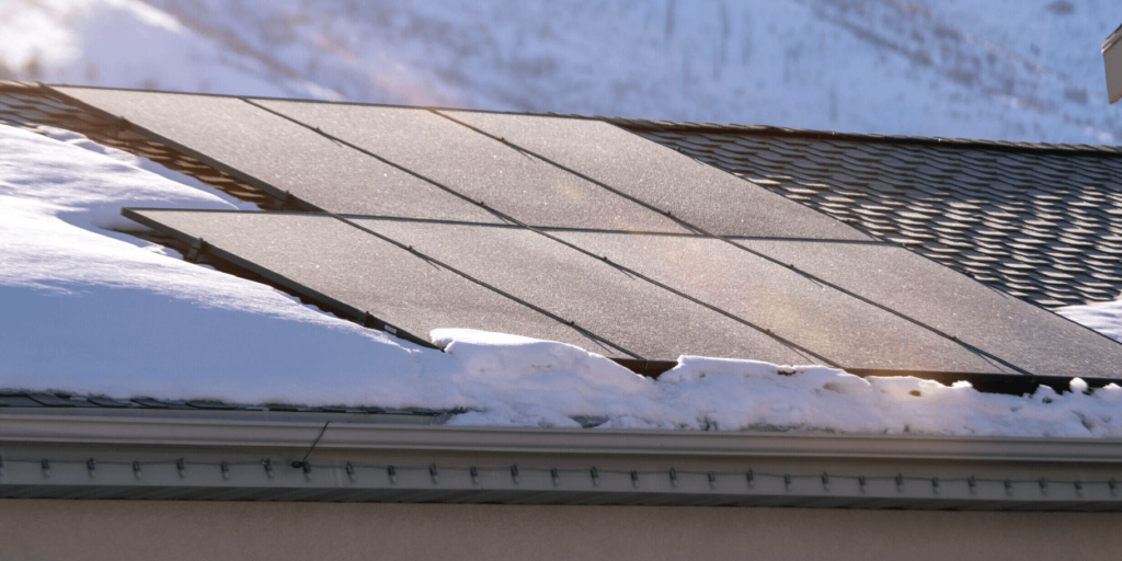 Seven PV panels installed on roof, surrounded by snow
