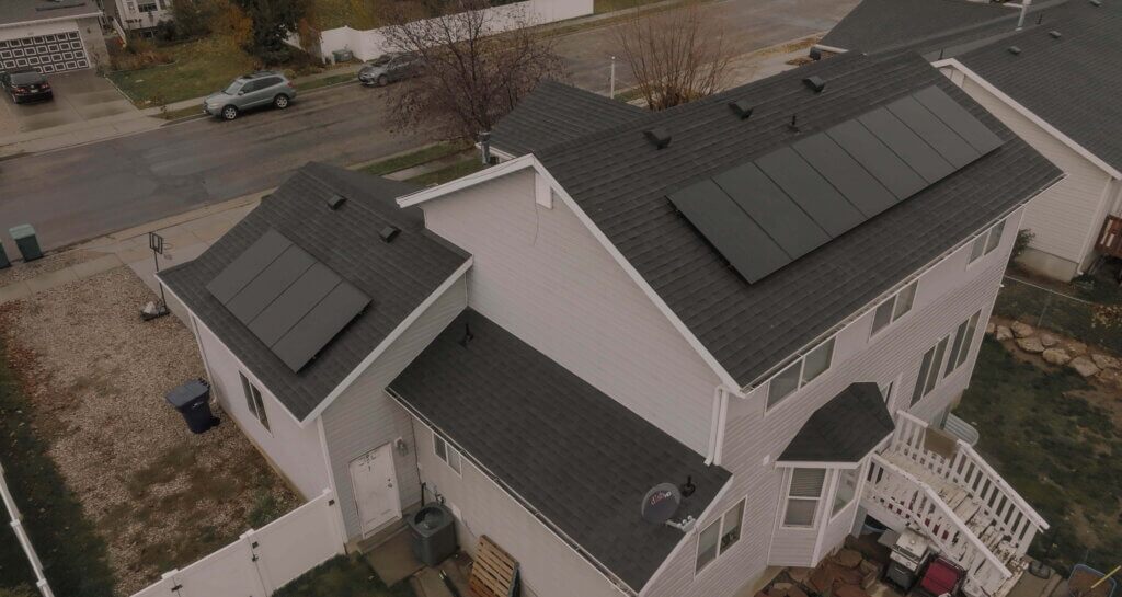 The Best Direction for Your Solar Panels-01 Aerial shot of a large two-story house with solar panels installed on different pitches