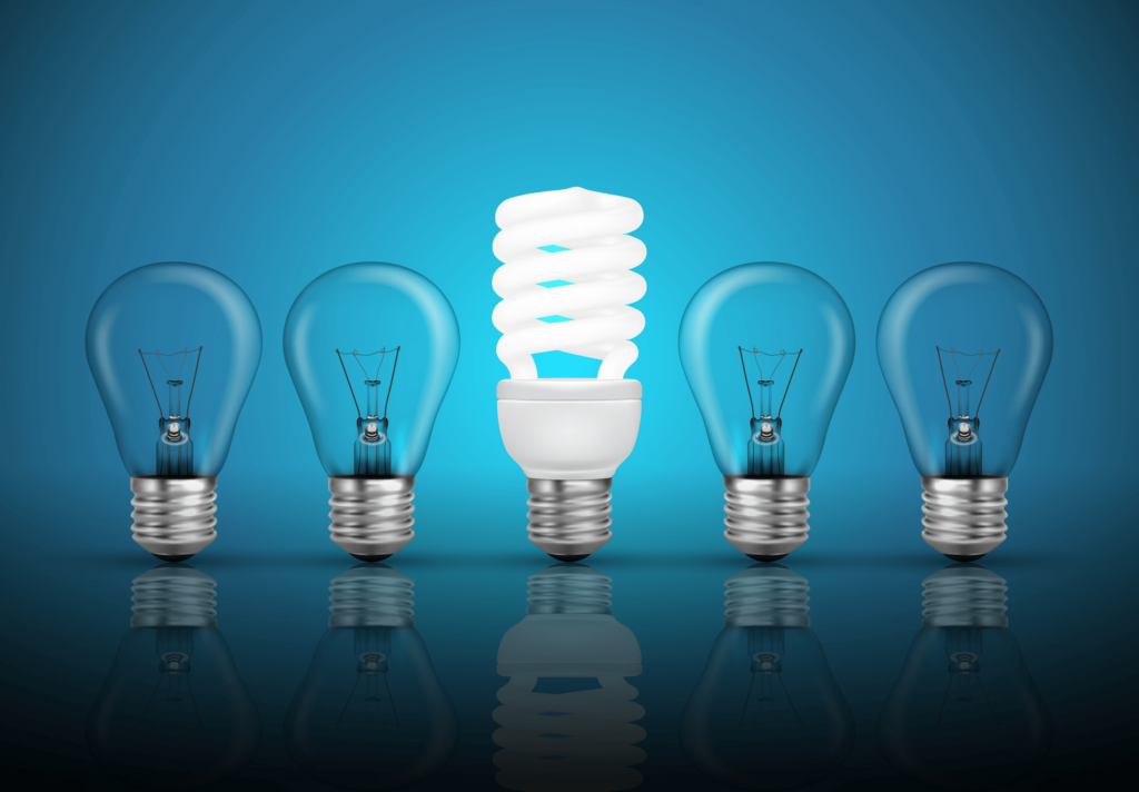 Essential Winter Energy Saving Tips-02 Five light bulbs in a row with one LED shining in the middle on a blue background