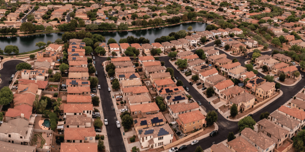 HOAs and Solar Panels-01 Aerial view of dense neighborhoods with a body of water in the middle