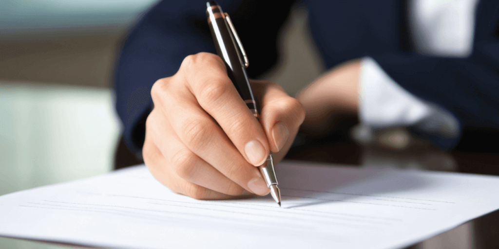 HOAs and Solar Panels-03 Human hand holding a pen writing on paper