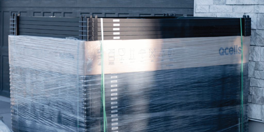 What is the Size of a Solar Panel-01 Stack of monocrystalline solar panels, wrapped, in preparation to be installed