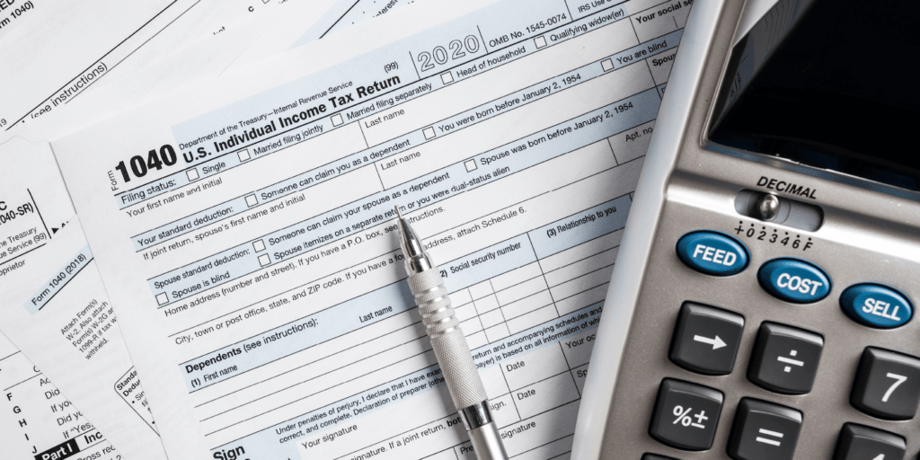 Benefits of Investing in Solar Battery Storage-04 Tax forms fanned out with a silver pen and calculator