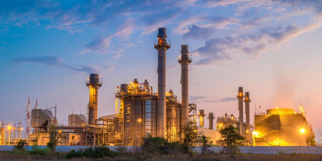 Traditional power plant with wispy clouds and bright lights